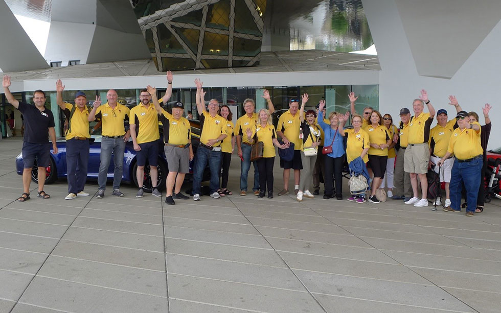 The travel group lined up and waving