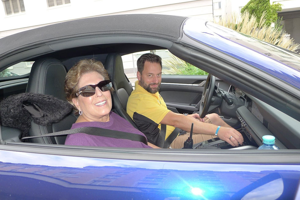 A happy couple in their Porsche