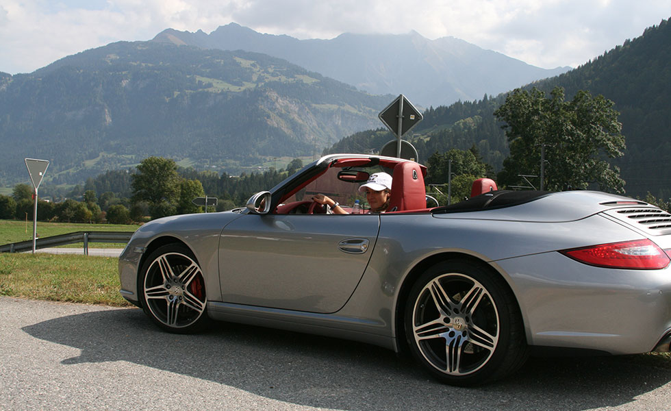 Happy woman in porsche