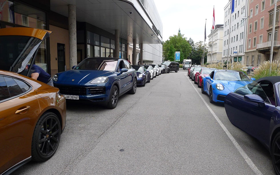 Two rows of parked Porsches