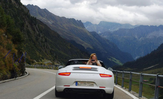 Girl hanging out of new porsche