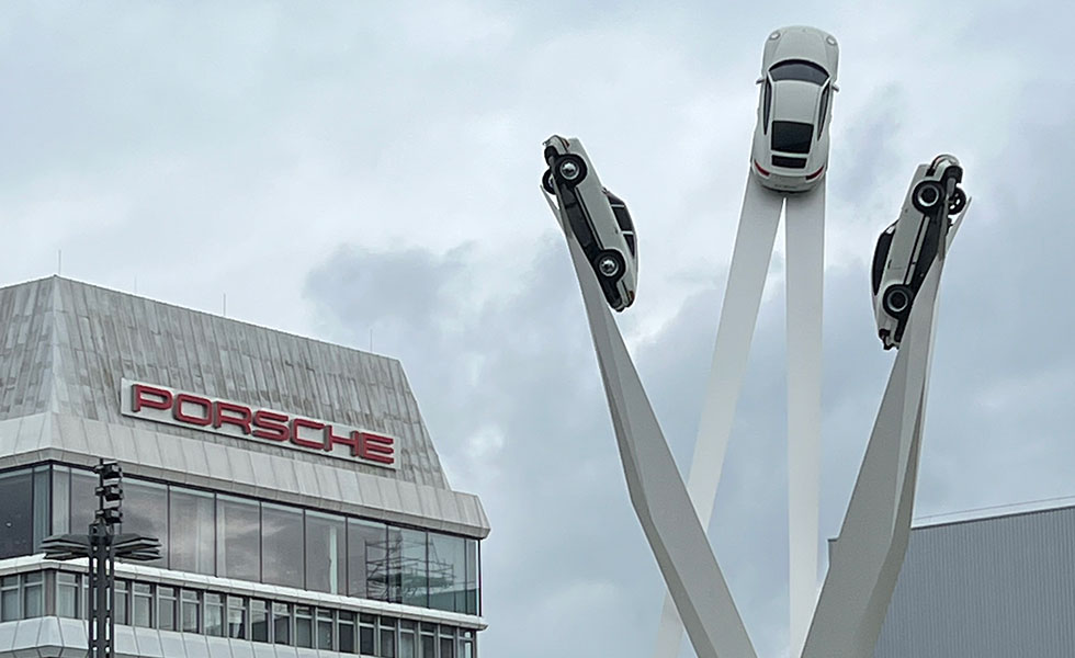 porsche factory with 3 cars statue