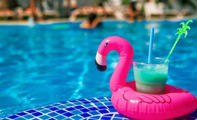pink flamingo floating in pool